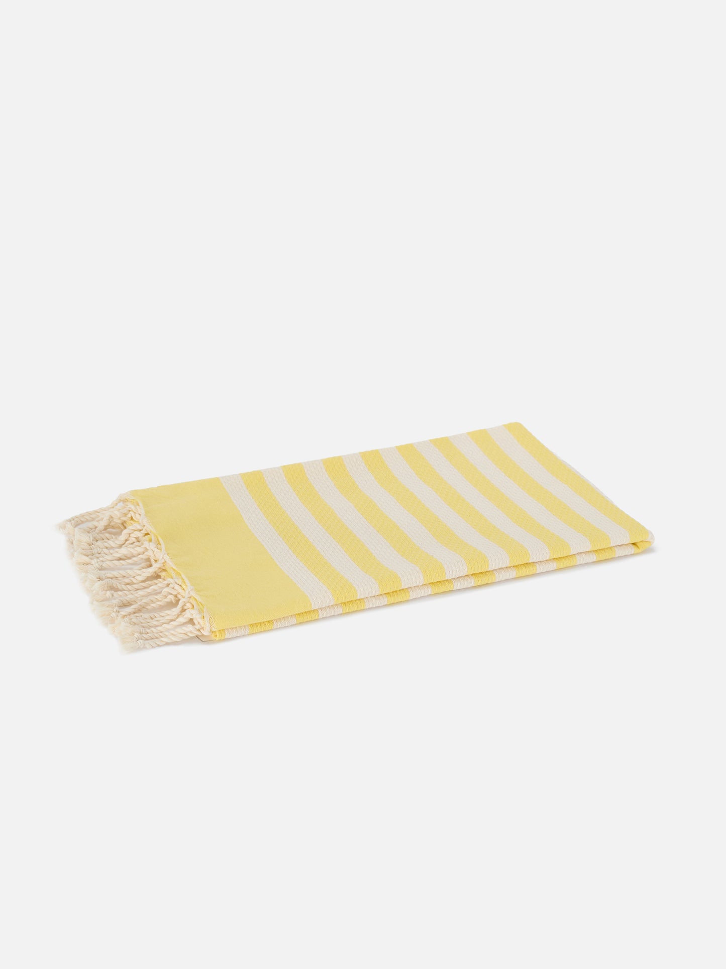 Toalla de playa fouta con rayas amarillas y blancas