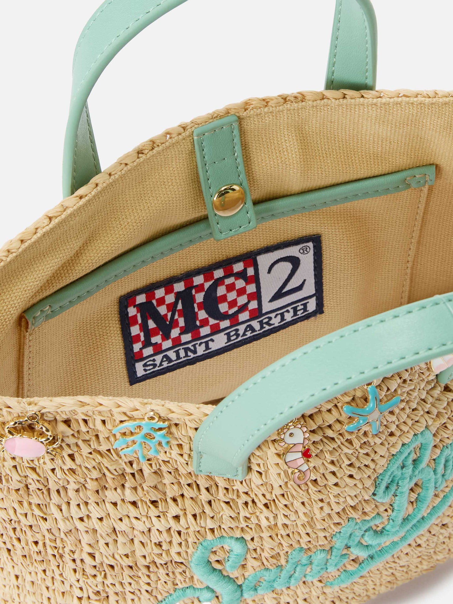 City mini raffia bag with applied charms and embroidered logo